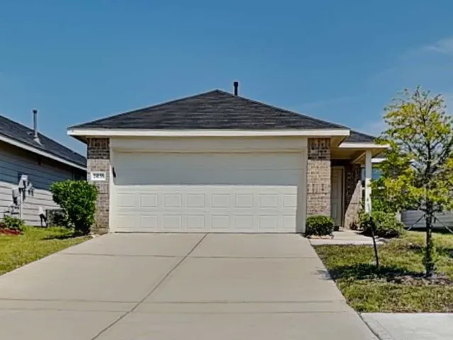 a front view of a house with a yard and a garage