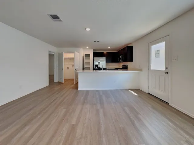 a kitchen with stainless steel appliances a refrigerator stove and kitchen island
