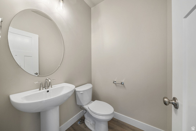 175 West 930 North Santaquin, UT 84655 - Photo 20 of 22 Pedestal sink with chrome faucet, complemented by an oval wall-mounted mirror and overhead lighting