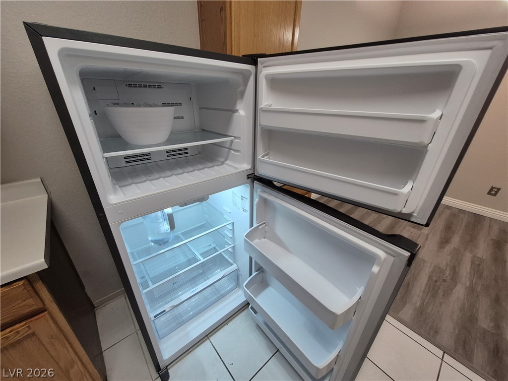 2053 Quarry Ridge Street, Unit 201 Las Vegas, NV 89117 - Photo 18 of 21 A well-lit, open refrigerator awaits groceries.