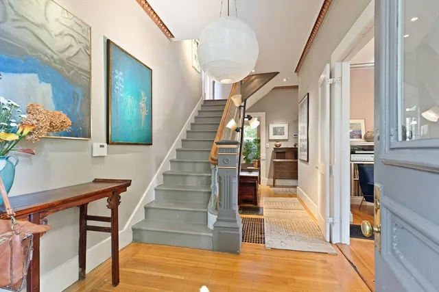 a view of entryway and hall with wooden floor