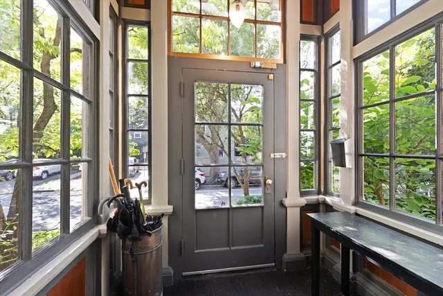 a room with large windows and furniture