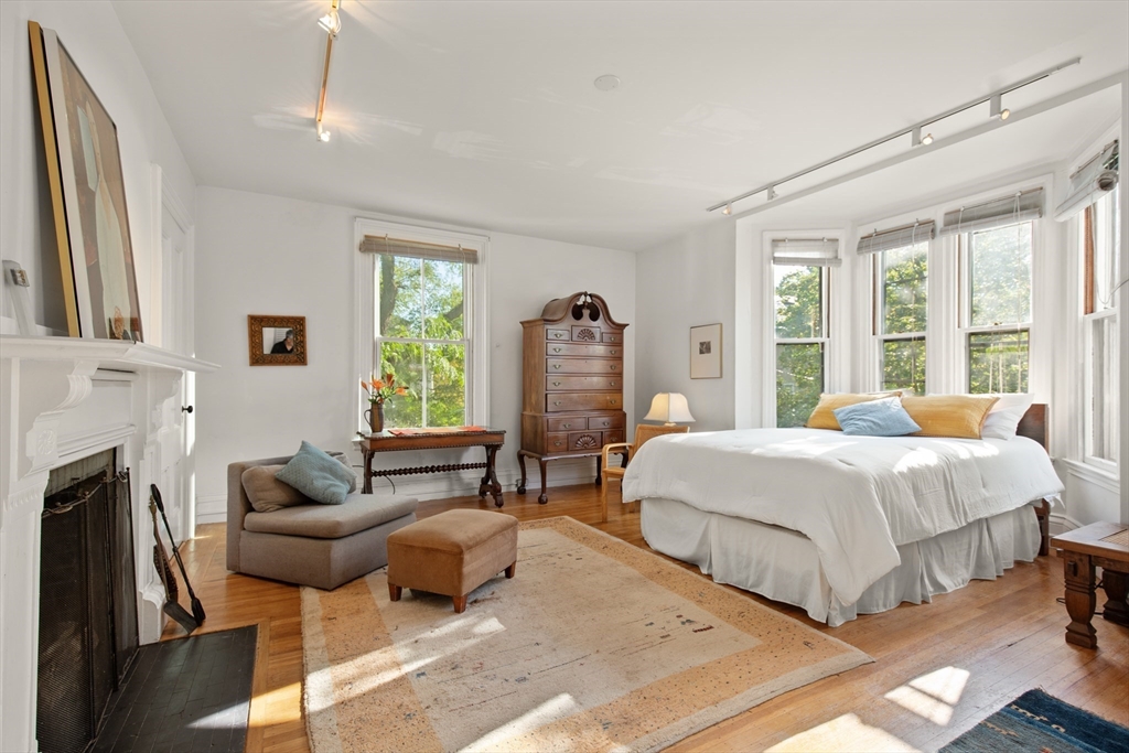 32 Hawthorn Street Cambridge, MA 02138 - Photo 20 of 42 a bed room with a bed and a fireplace