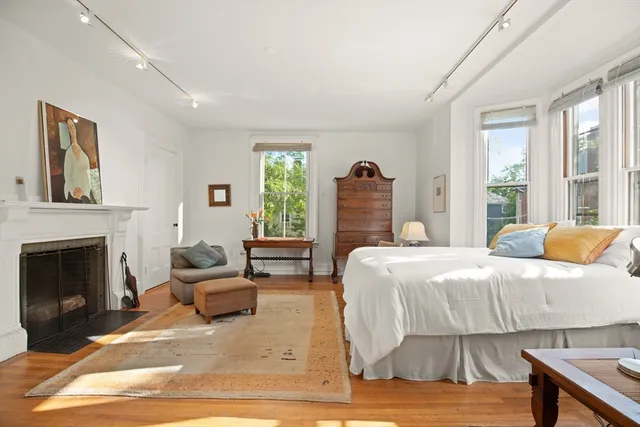 a bedroom with a bed and a fireplace