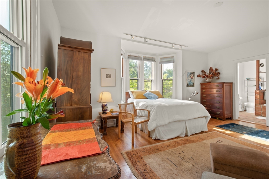 32 Hawthorn Street Cambridge, MA 02138 - Photo 22 of 42 a bedroom with a bed table flowerpot and window