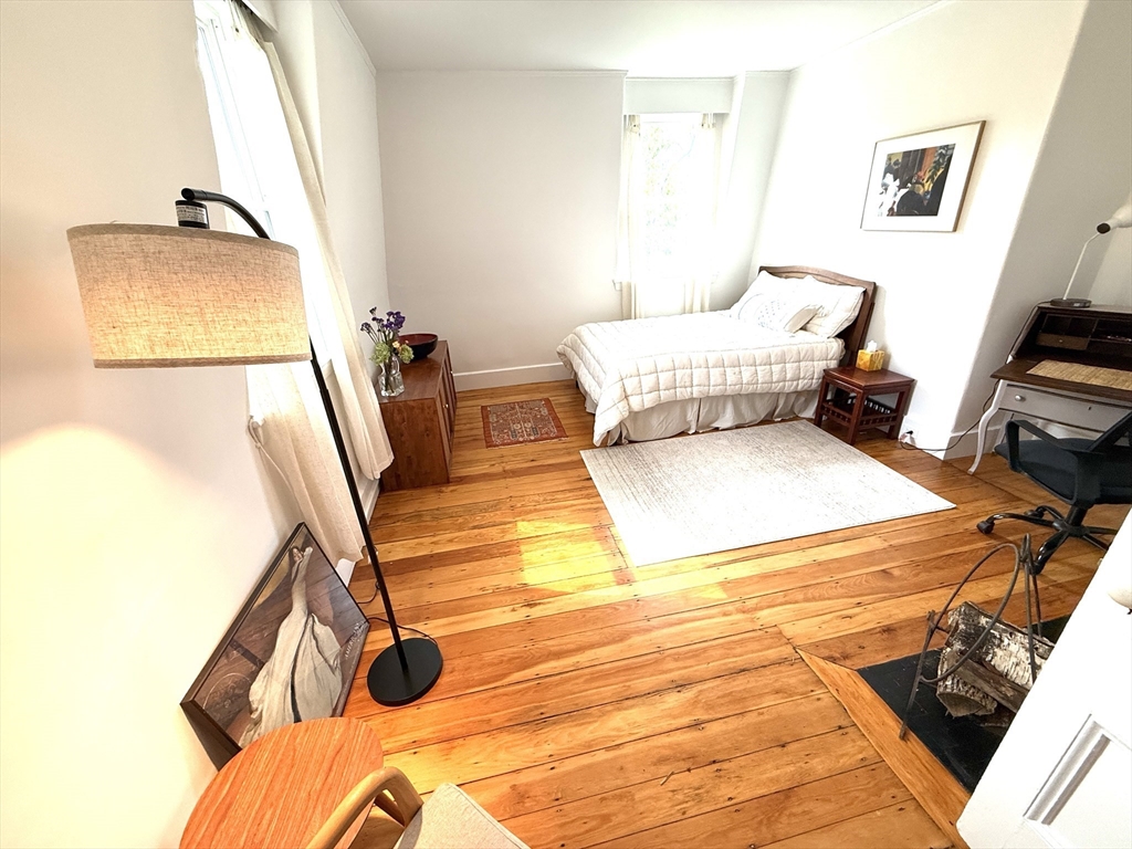 32 Hawthorn Street Cambridge, MA 02138 - Photo 30 of 42 a bedroom with a bed and wooden floor