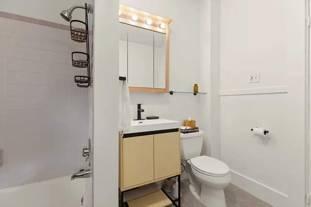a white toilet sitting next to a bathroom sink