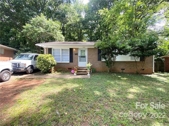 3239 Edsel Place Charlotte, NC 28205 - Photo 2 of 9 a backyard of a house with table and chairs plants
