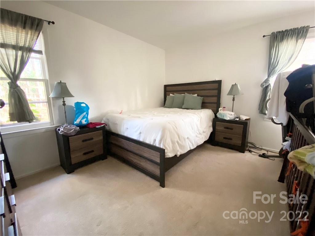 3239 Edsel Place Charlotte, NC 28205 - Photo 5 of 9 a bedroom with a bed and windows