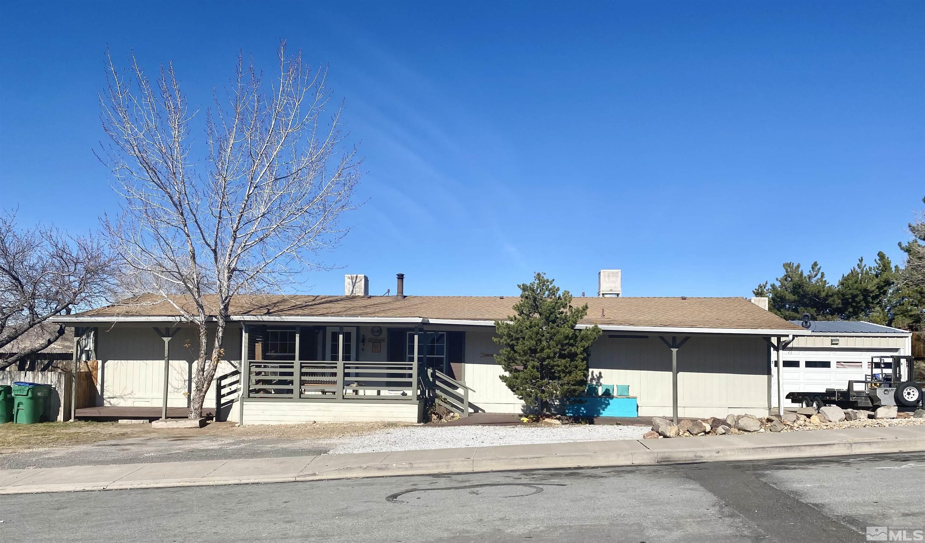 1489 Kate Lane Reno, NV 89506 - Photo 1 of 23 a view of a house with a yard and potted plants