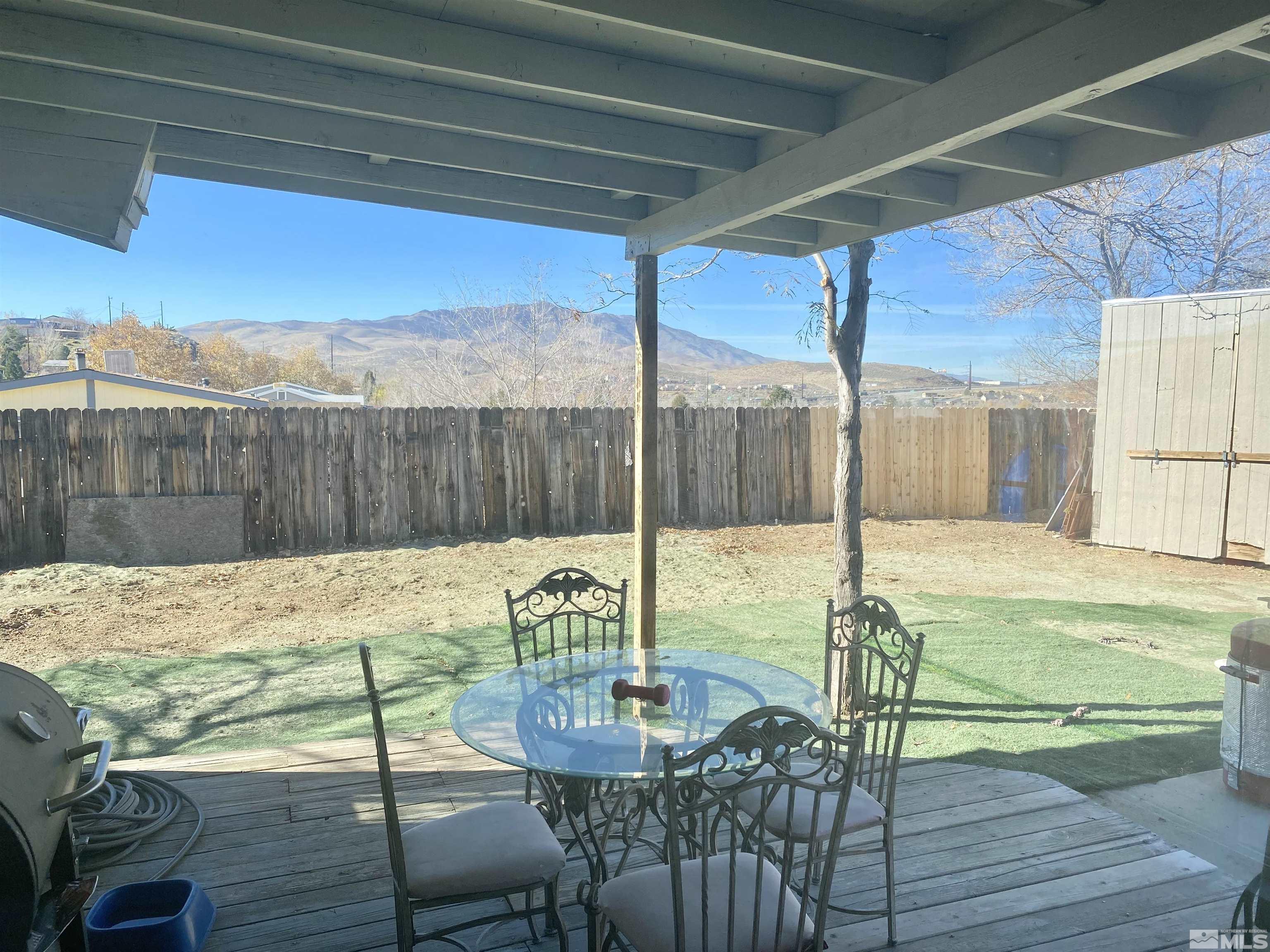 1489 Kate Lane Reno, NV 89506 - Photo 22 of 23 a view of a patio with a table chairs and wooden floor