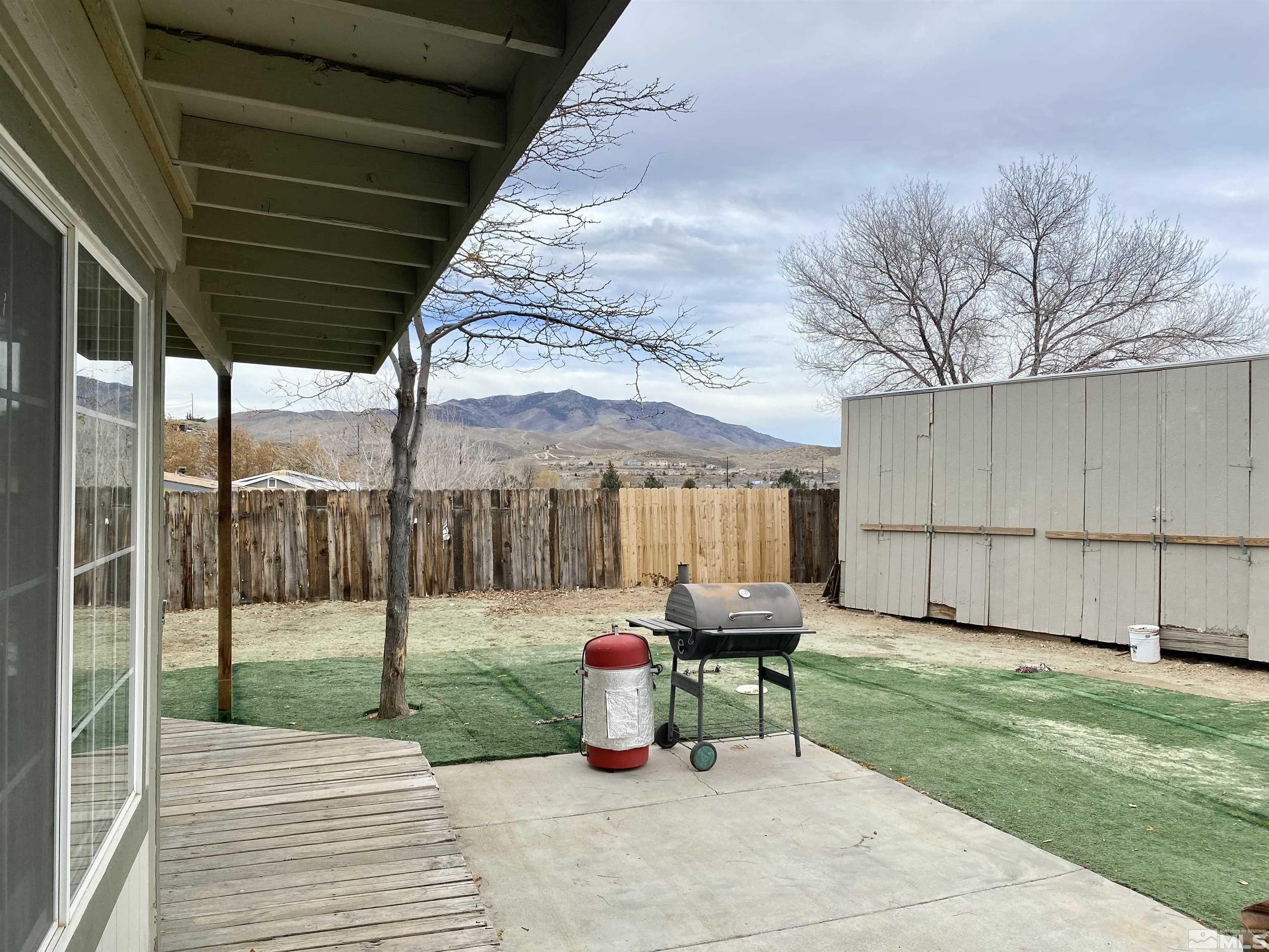 1489 Kate Lane Reno, NV 89506 - Photo 23 of 23 a backyard view of a house with trampoline fire pit tables and chairs