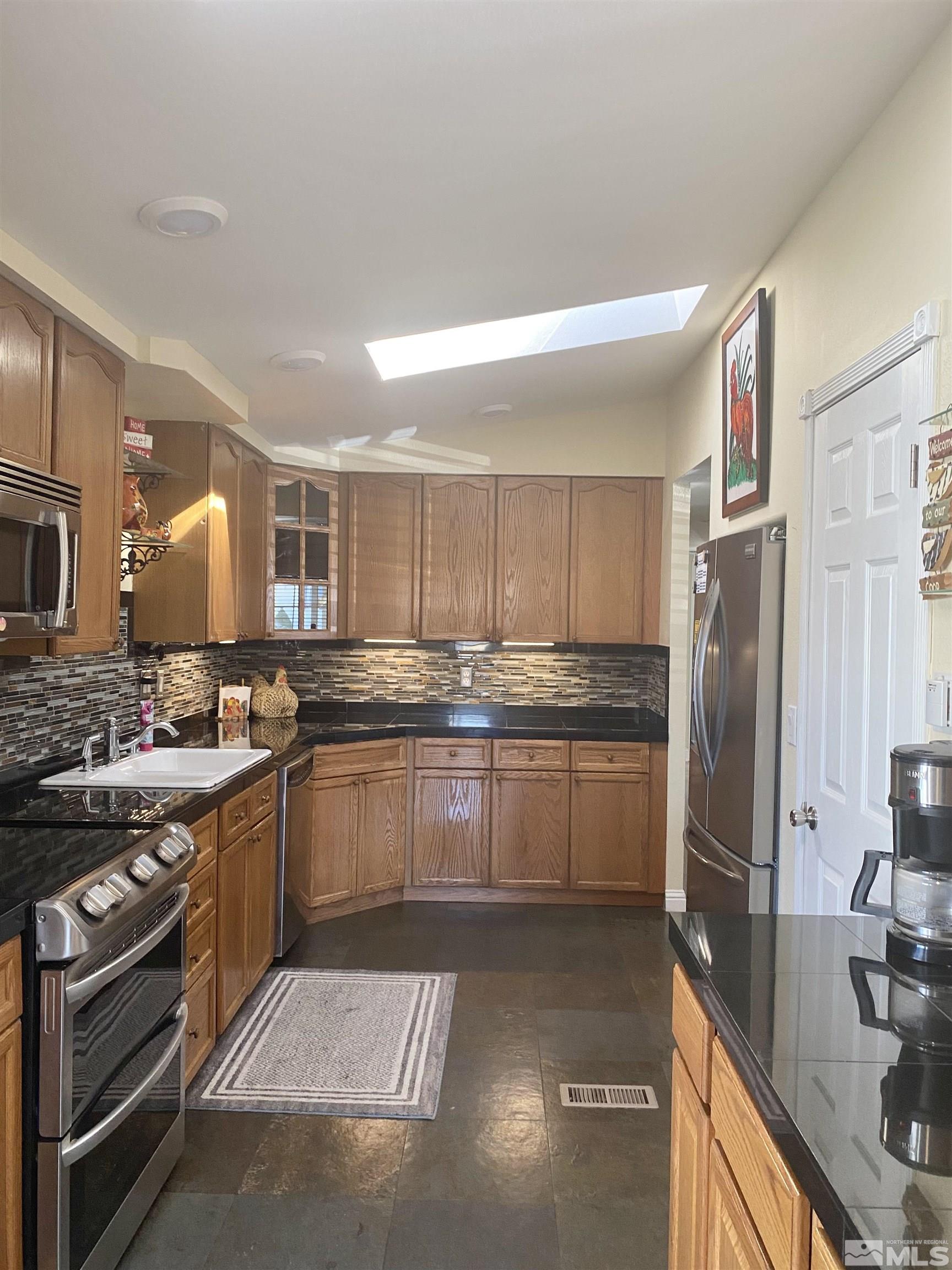 1489 Kate Lane Reno, NV 89506 - Photo 9 of 23 a kitchen with a sink stove and refrigerator