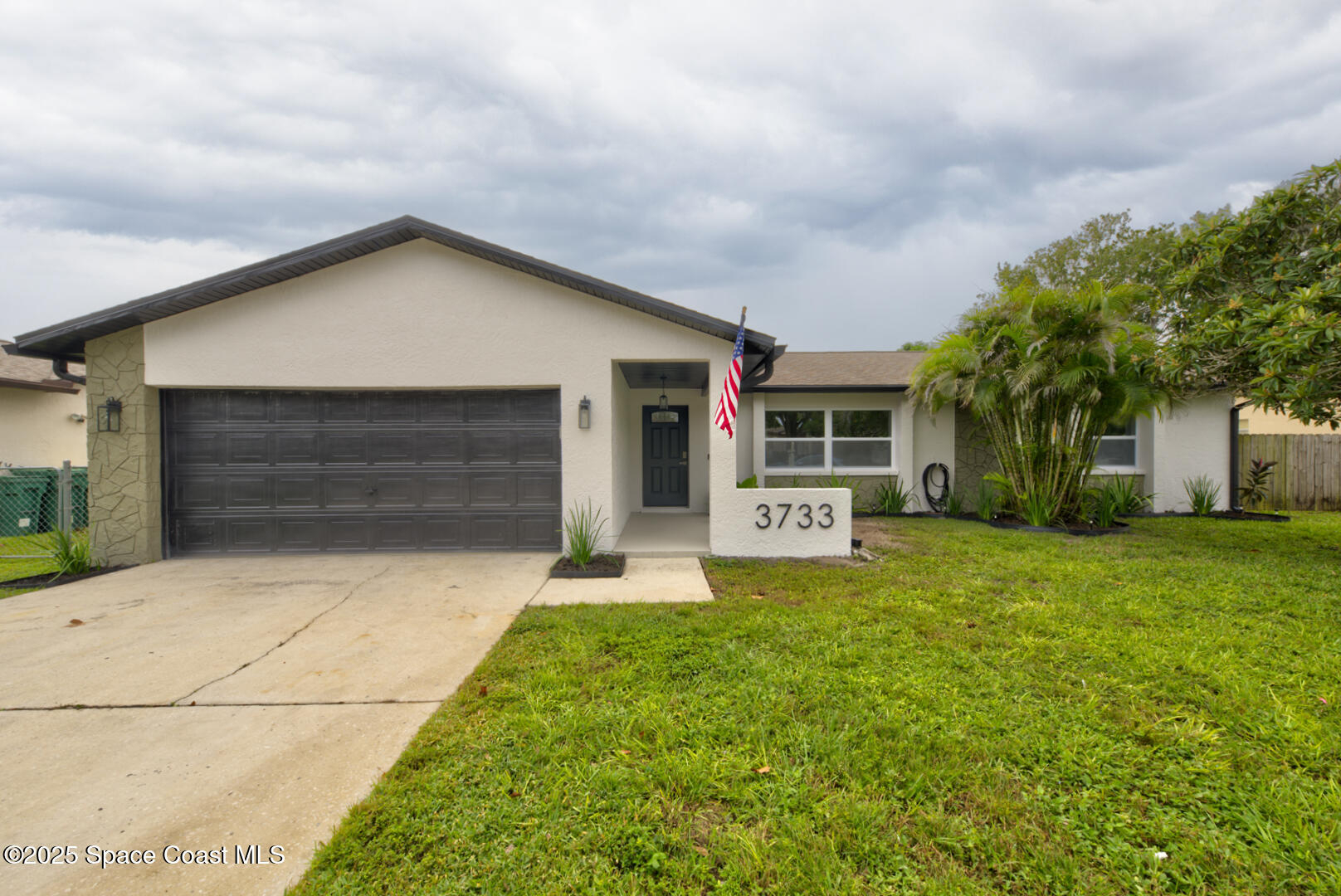 3733 Crossbow Drive Cocoa, FL 32926 - Photo 1 of 25 a front view of house with yard and green space
