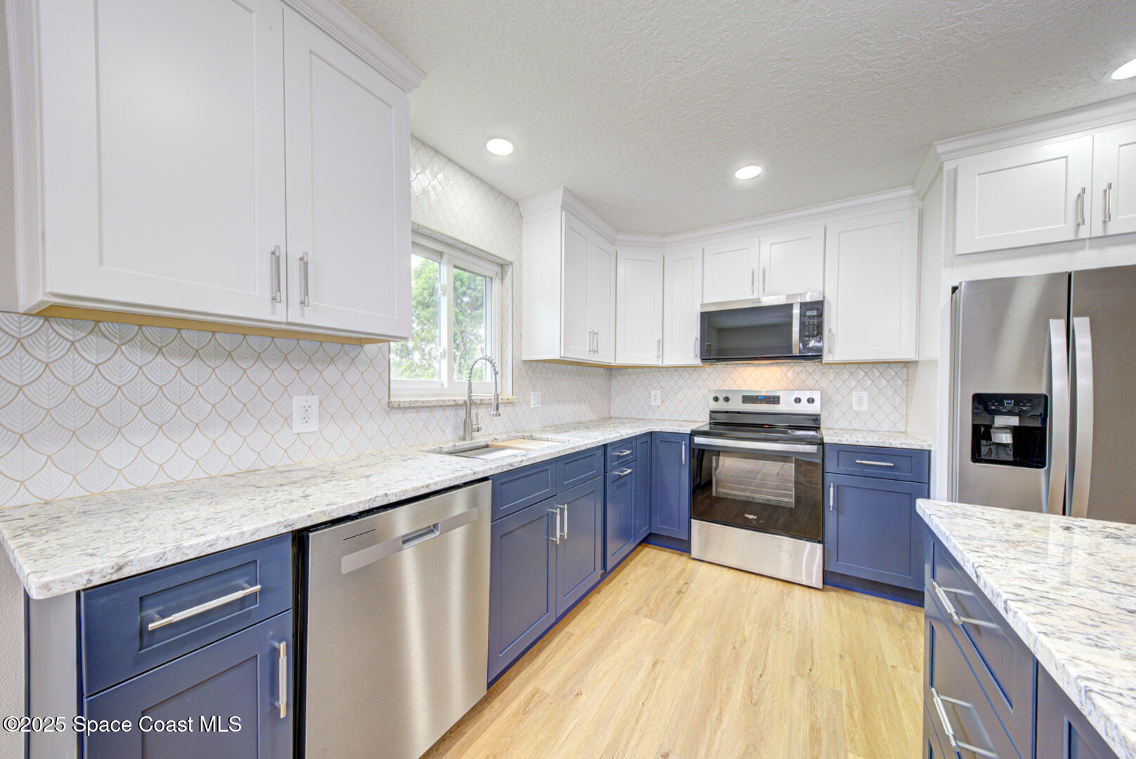 3733 Crossbow Drive Cocoa, FL 32926 - Photo 12 of 25 a kitchen with stainless steel appliances granite countertop a sink dishwasher stove and refrigerator