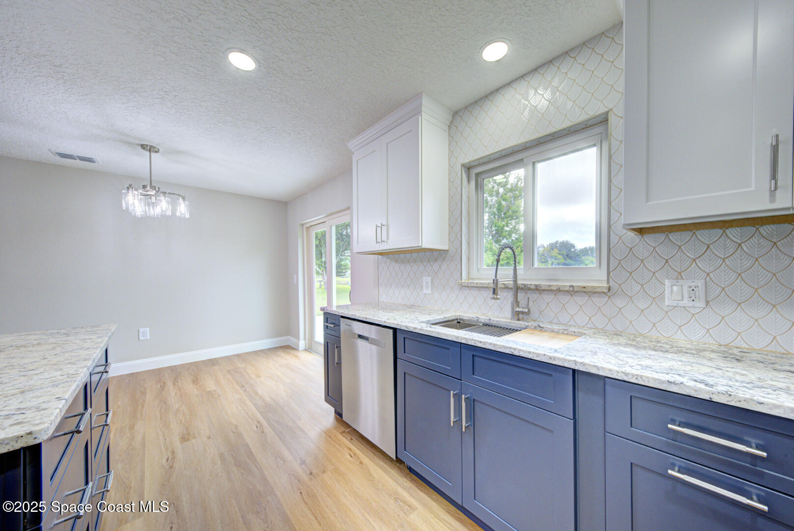 3733 Crossbow Drive Cocoa, FL 32926 - Photo 13 of 25 a kitchen with a sink window and cabinets