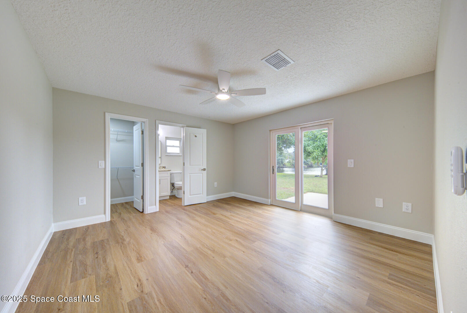3733 Crossbow Drive Cocoa, FL 32926 - Photo 15 of 25 a view of an empty room with wooden floor and a window