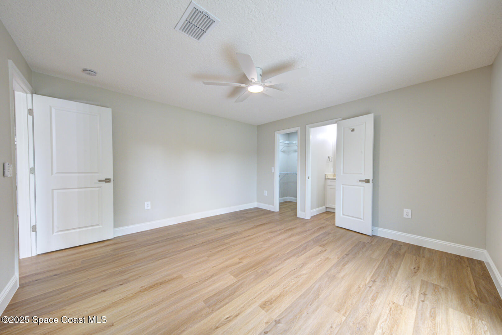 3733 Crossbow Drive Cocoa, FL 32926 - Photo 16 of 25 a view of an empty room and window a ceiling fan and wooden floor