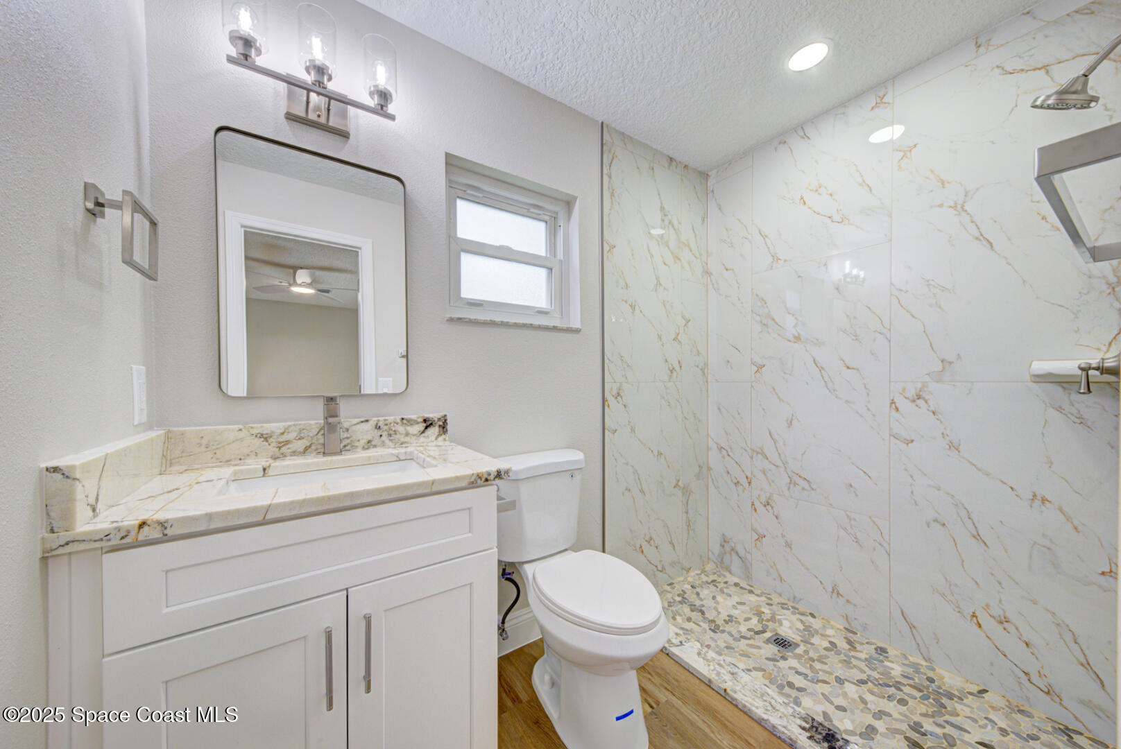 3733 Crossbow Drive Cocoa, FL 32926 - Photo 17 of 25 a bathroom with a toilet sink vanity and mirror