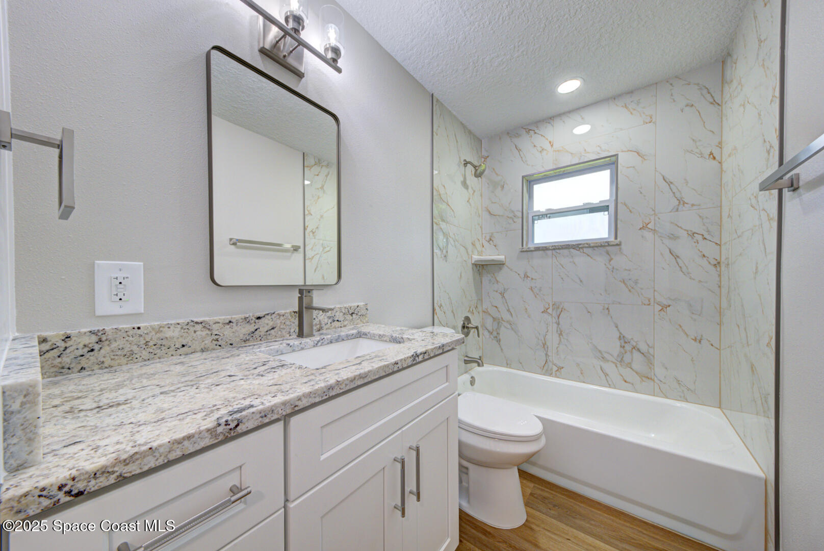 3733 Crossbow Drive Cocoa, FL 32926 - Photo 20 of 25 a bathroom with a granite countertop sink a toilet and bathtub