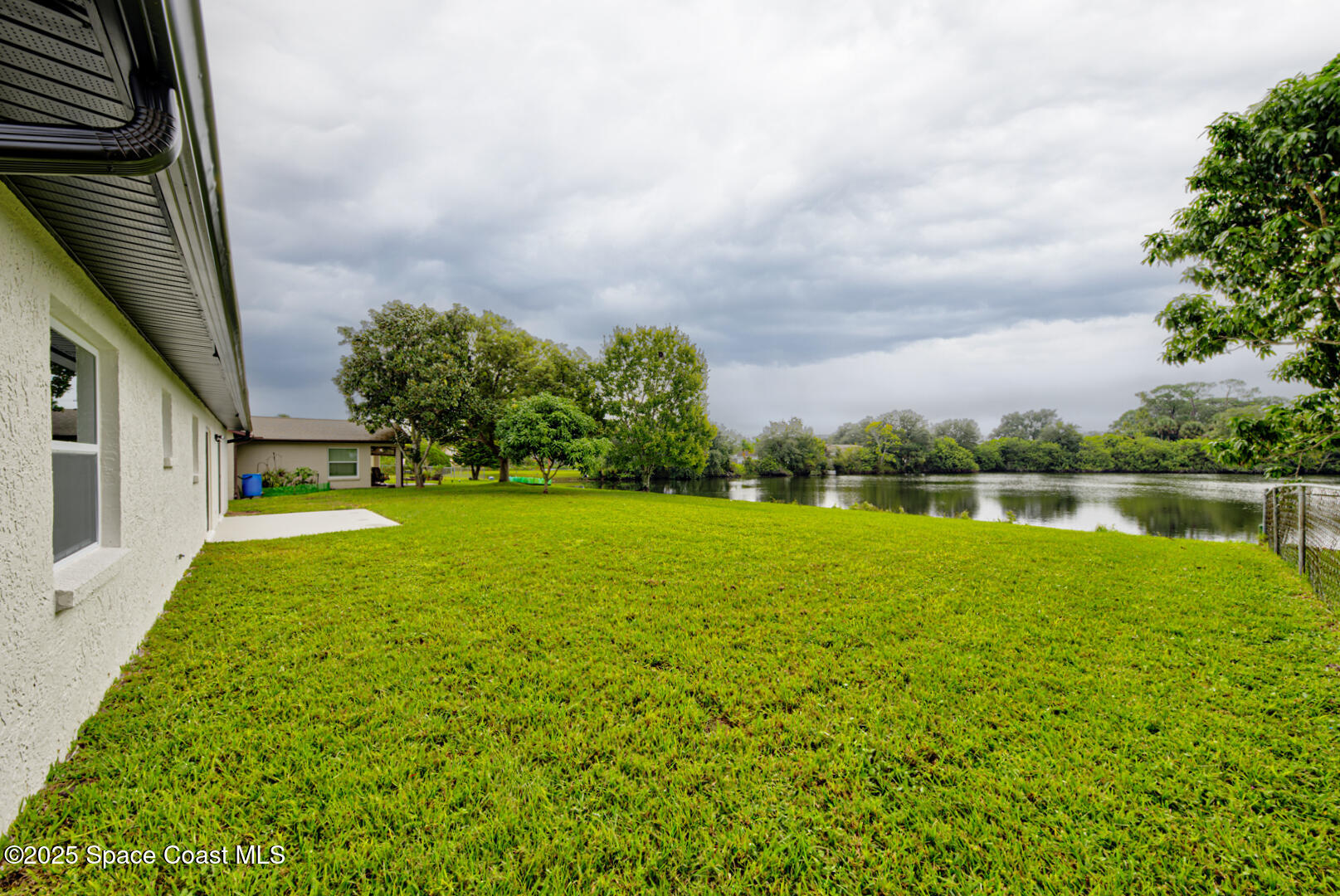 3733 Crossbow Drive Cocoa, FL 32926 - Photo 21 of 25 a view of a lake with a yard