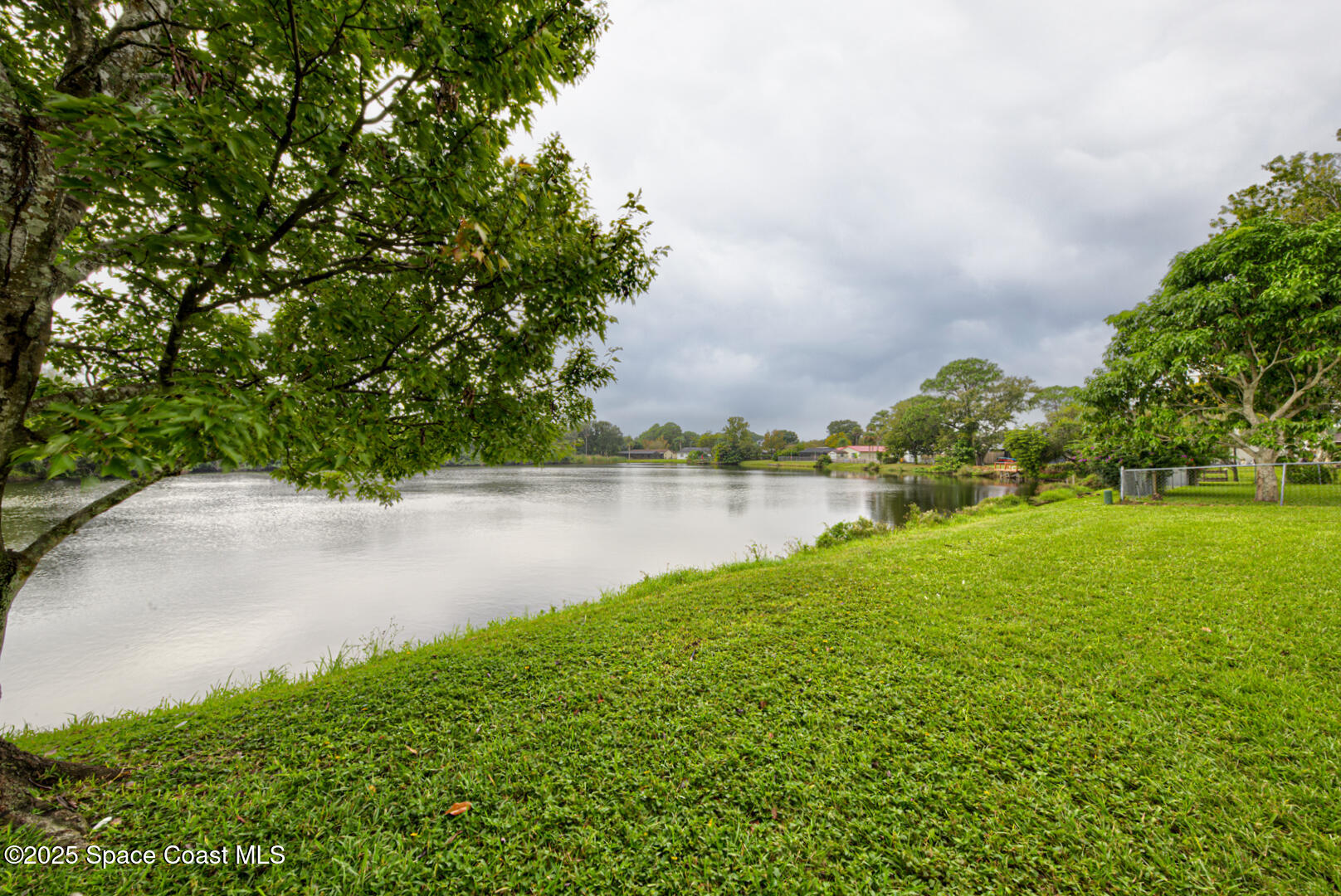 3733 Crossbow Drive Cocoa, FL 32926 - Photo 23 of 25 a view of a lake with a yard