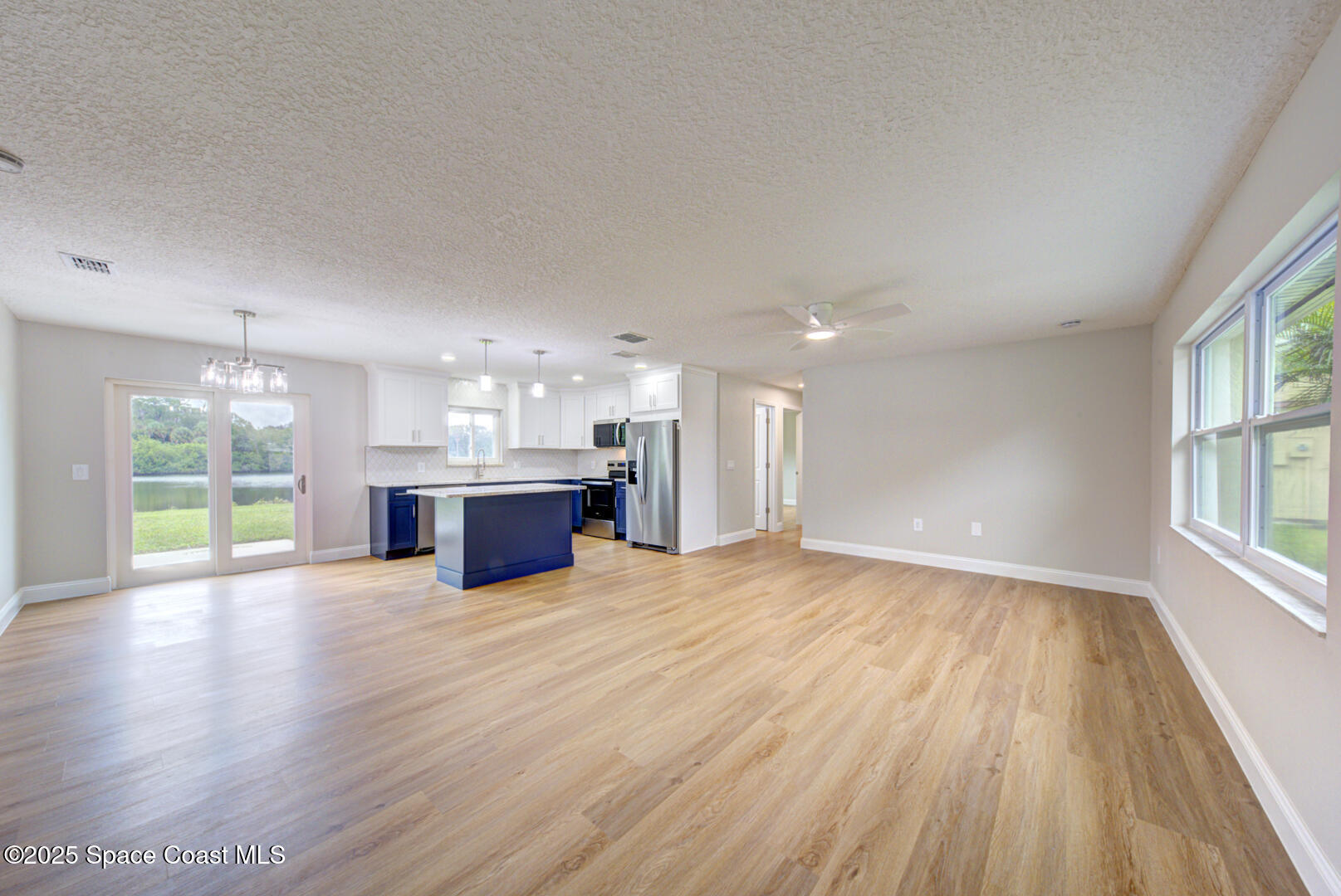 3733 Crossbow Drive Cocoa, FL 32926 - Photo 5 of 25 a view of an empty room with wooden floor and a window