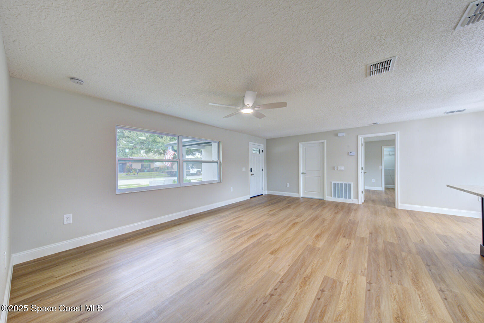 3733 Crossbow Drive Cocoa, FL 32926 - Photo 8 of 25 an empty room with wooden floor and windows