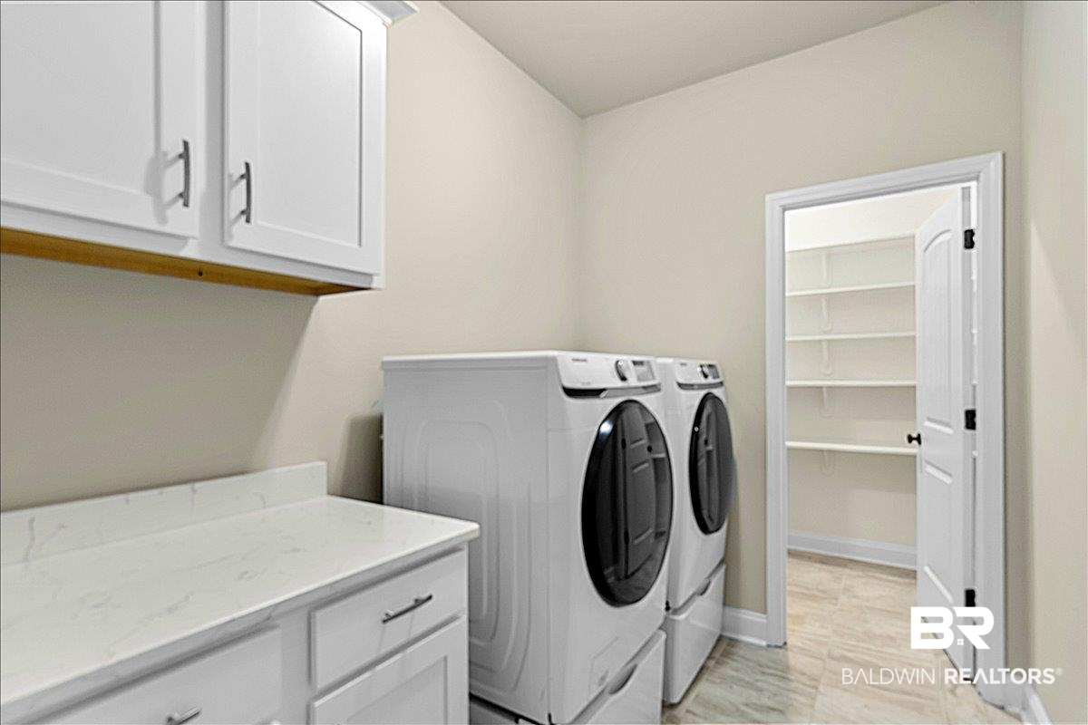 1112 Stella Road Foley, AL 36535 - Photo 12 of 33 Laundry area with washing machine and dryer and cabinet space
