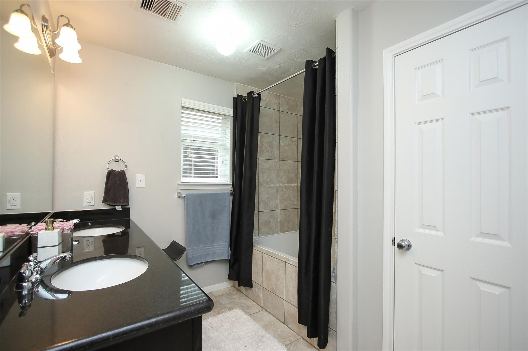 8517 Sunset Loch Drive Spring, TX 77379 - Photo 15 of 22 a bathroom with 2 sink and a mirror