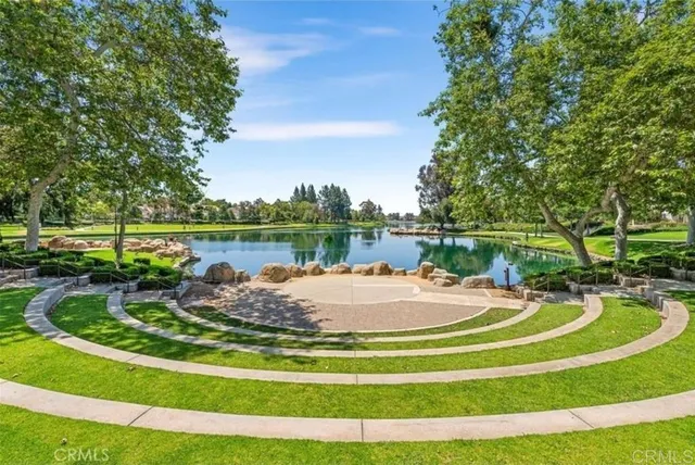 a view of a swimming pool with a patio and a yard