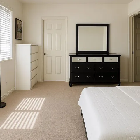 a bedroom with a bed and a dresser