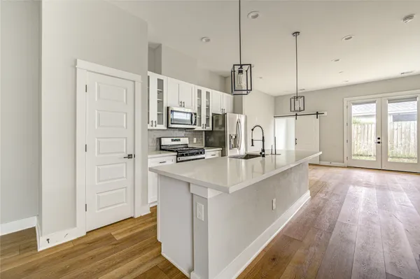 a kitchen with stainless steel appliances a stove a microwave and cabinets