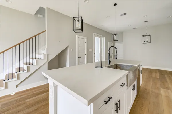 a kitchen with a sink a faucet a stove and refrigerator