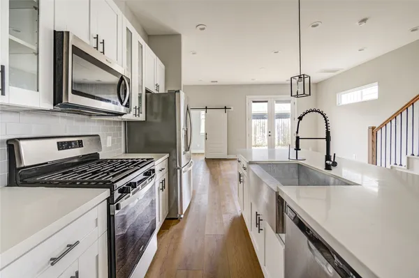 a view of a kitchen with wooden floor and stairs
