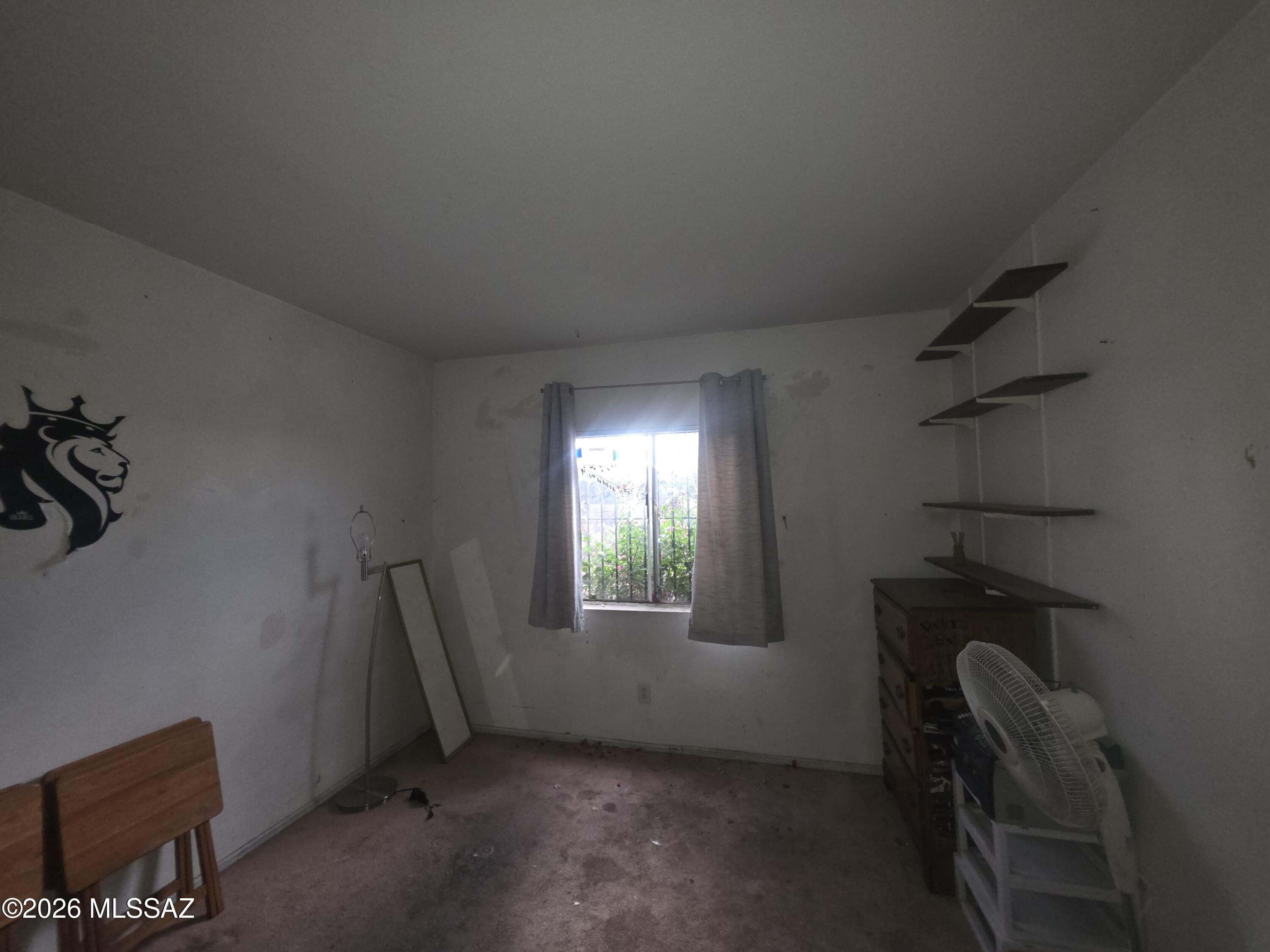 211 West Roger Road, Unit 24 Tucson, AZ 85705 - Photo 14 of 24 a view of an empty room with a window