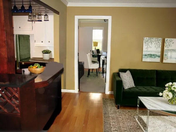 a living room with furniture and wooden floor