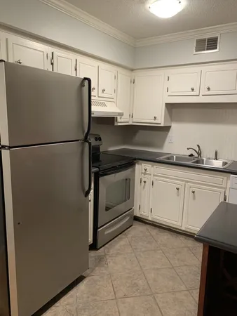 a white refrigerator freezer sitting inside of a kitchen