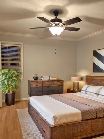 a bedroom with a bed and ceiling fan
