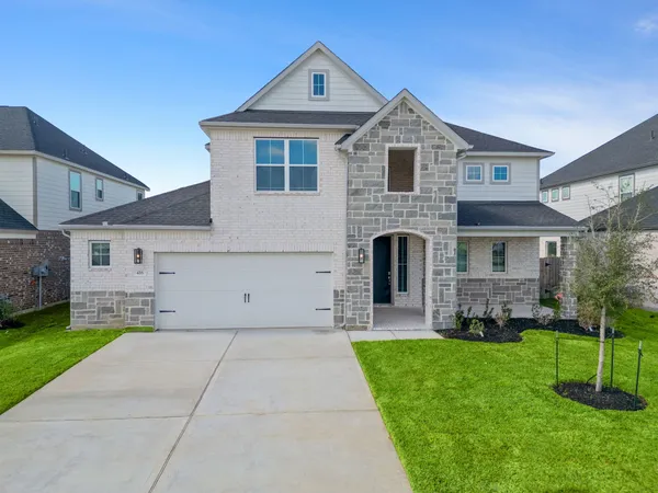 a front view of house with yard and green space