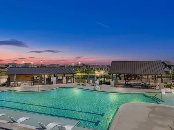 a view of a swimming pool with a table and chairs