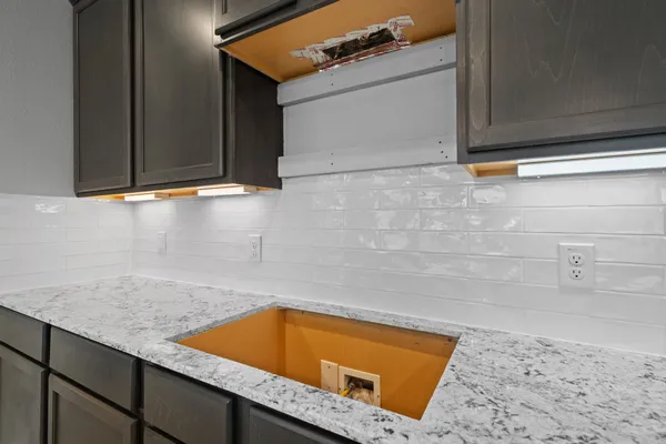 a room with a sink and cabinets