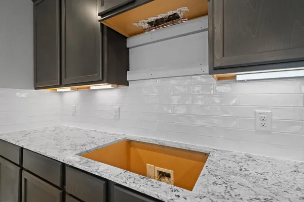 a room with a sink and cabinets