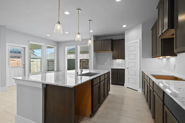 a open kitchen with stainless steel appliances granite countertop a sink stove and refrigerator