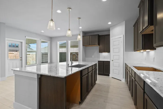 a open kitchen with stainless steel appliances granite countertop a sink stove and refrigerator