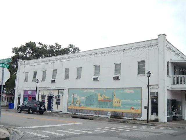 a view of building with car parked