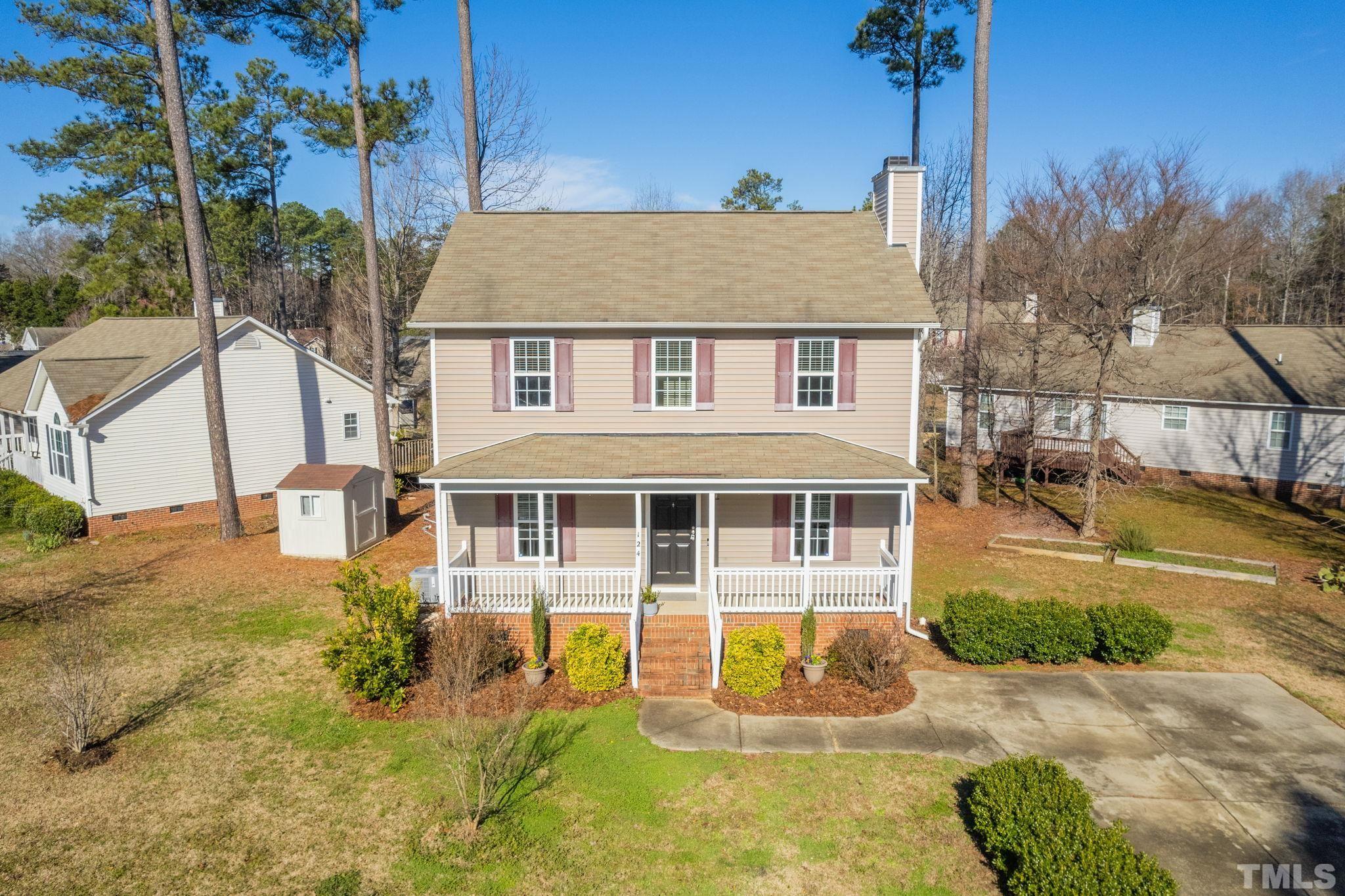 124 Gentle Rio Court Garner, NC 27529 - Photo 1 of 37 a view of a white house with large windows next to a yard