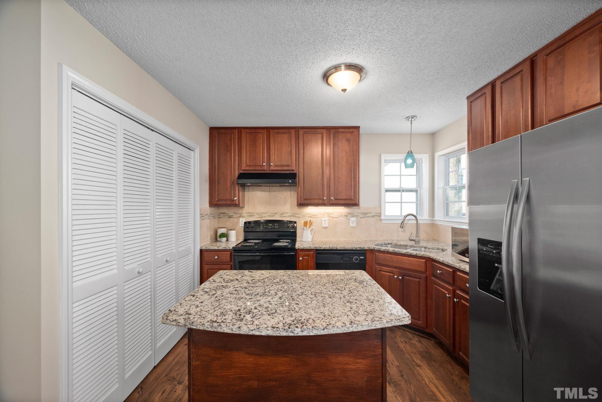124 Gentle Rio Court Garner, NC 27529 - Photo 19 of 37 a kitchen with stainless steel appliances granite countertop a sink stove and refrigerator