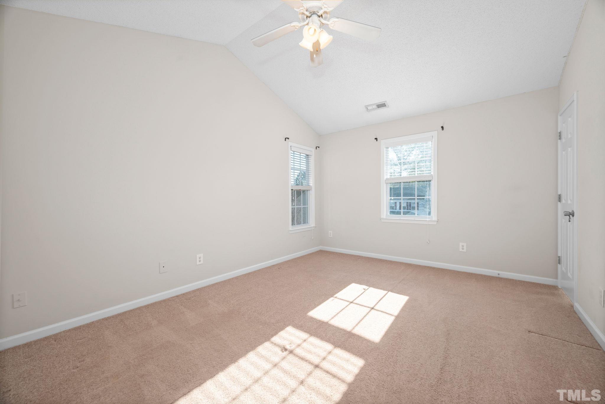 124 Gentle Rio Court Garner, NC 27529 - Photo 24 of 37 an empty room with windows and chandelier fan