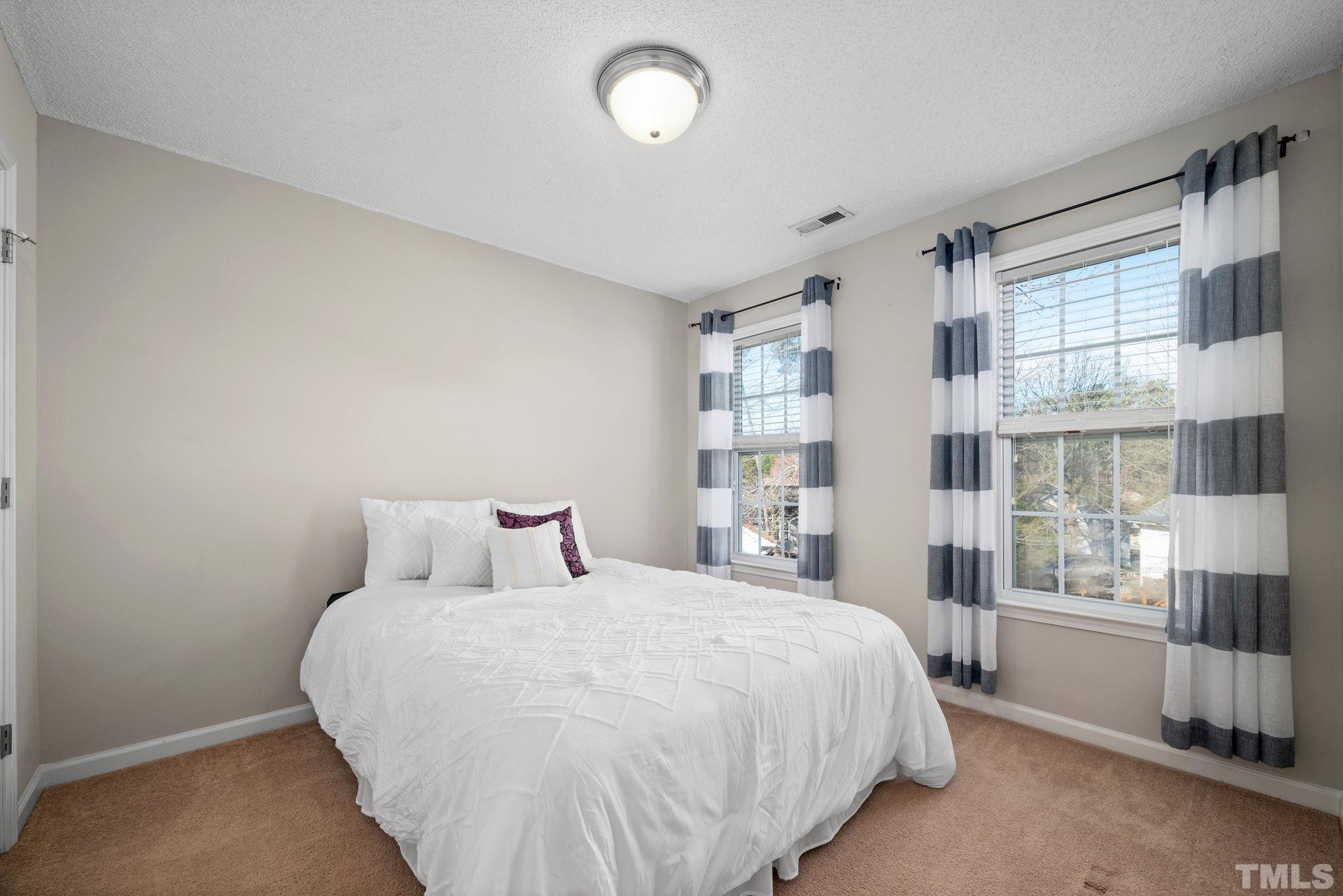 124 Gentle Rio Court Garner, NC 27529 - Photo 27 of 37 a bedroom with a large bed and a window